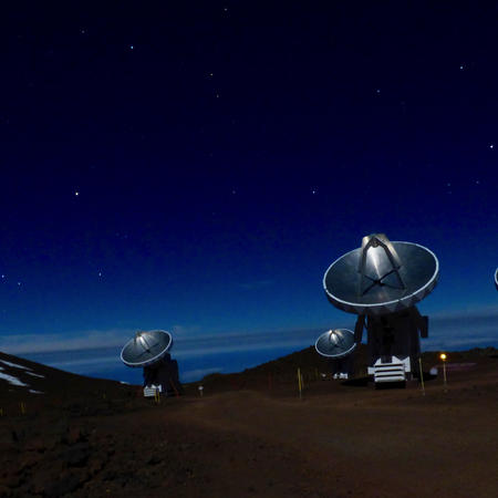 SMA telescopes at night under full moon