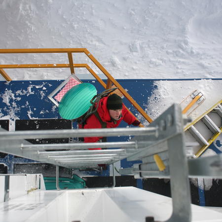 Wendy carrying the tertiary EHT mirror up to the cabin roof of the South Pole Telescope for a test run.