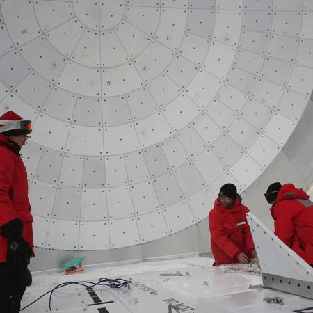 SPT scientists Dan, Wendy, Junhan, and Tom working on improvements to the EHT setup on the South Pole Telescope.
