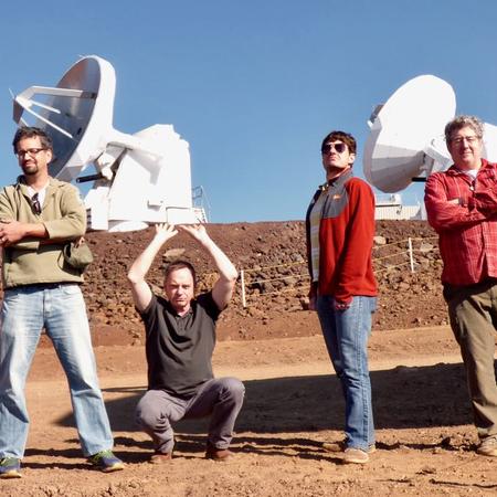 VLBI Team at SMA standing in front of telescope