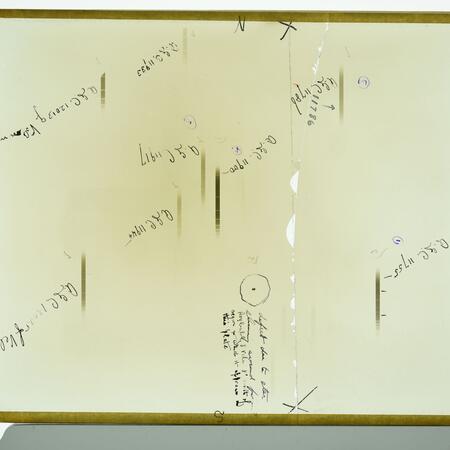 X04515 is a glass plate negative. It has markings denoting celestial objects. The plate was broken and mended by using tape to attach the glass plate to a piece of clear glass.