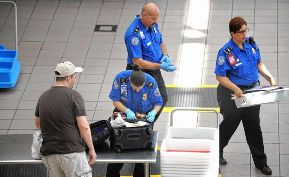 TSA officers inspecting luggage
