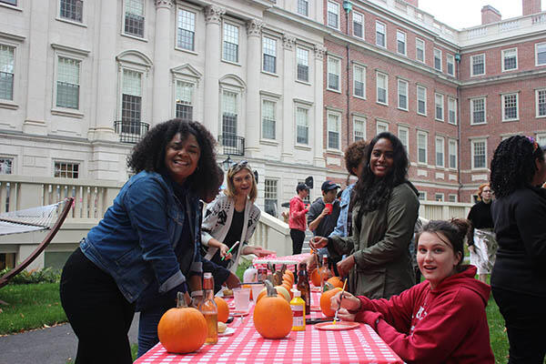 students painting pumpkins