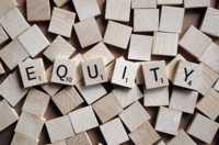 Background of scrabble tiles with "Equity" spelled on top