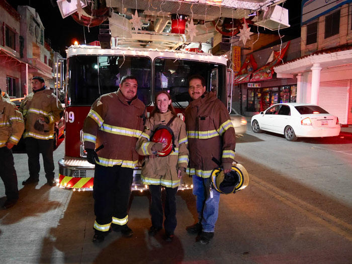 Image of Ieva Jusionyte with two Mexican firefighters