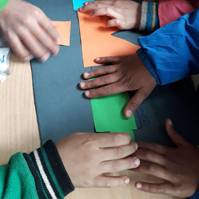 Image of student hands building a map