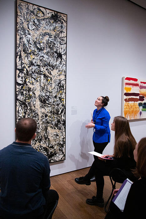 Jen Thum looks up at a 9 foot tall Jackson Pollock painting while facilitating a workshop at the Harvard Art Museums.