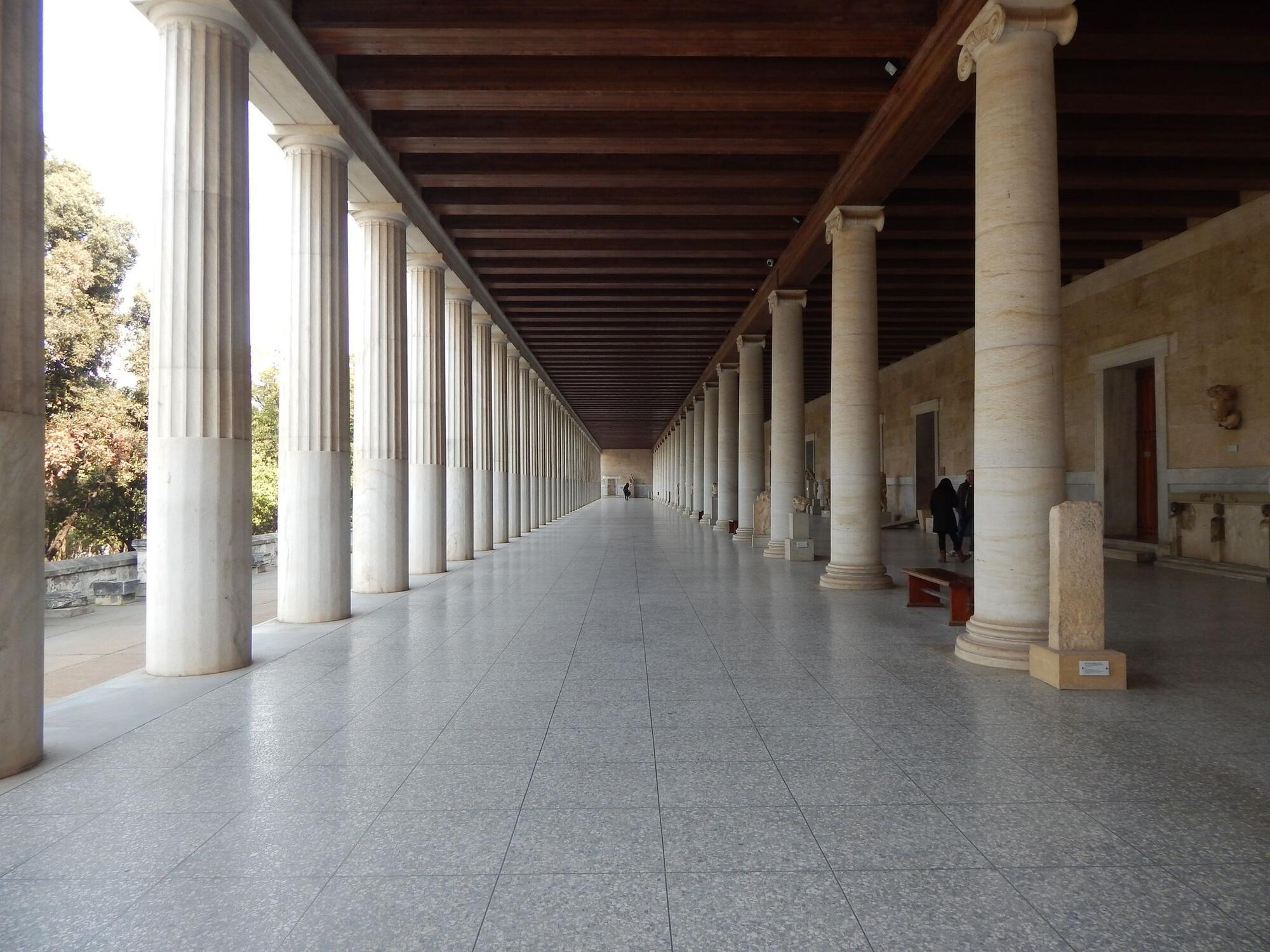 A wide corridor surrounded by ancient Greek style columns in Athens's Stoa of Attalos.