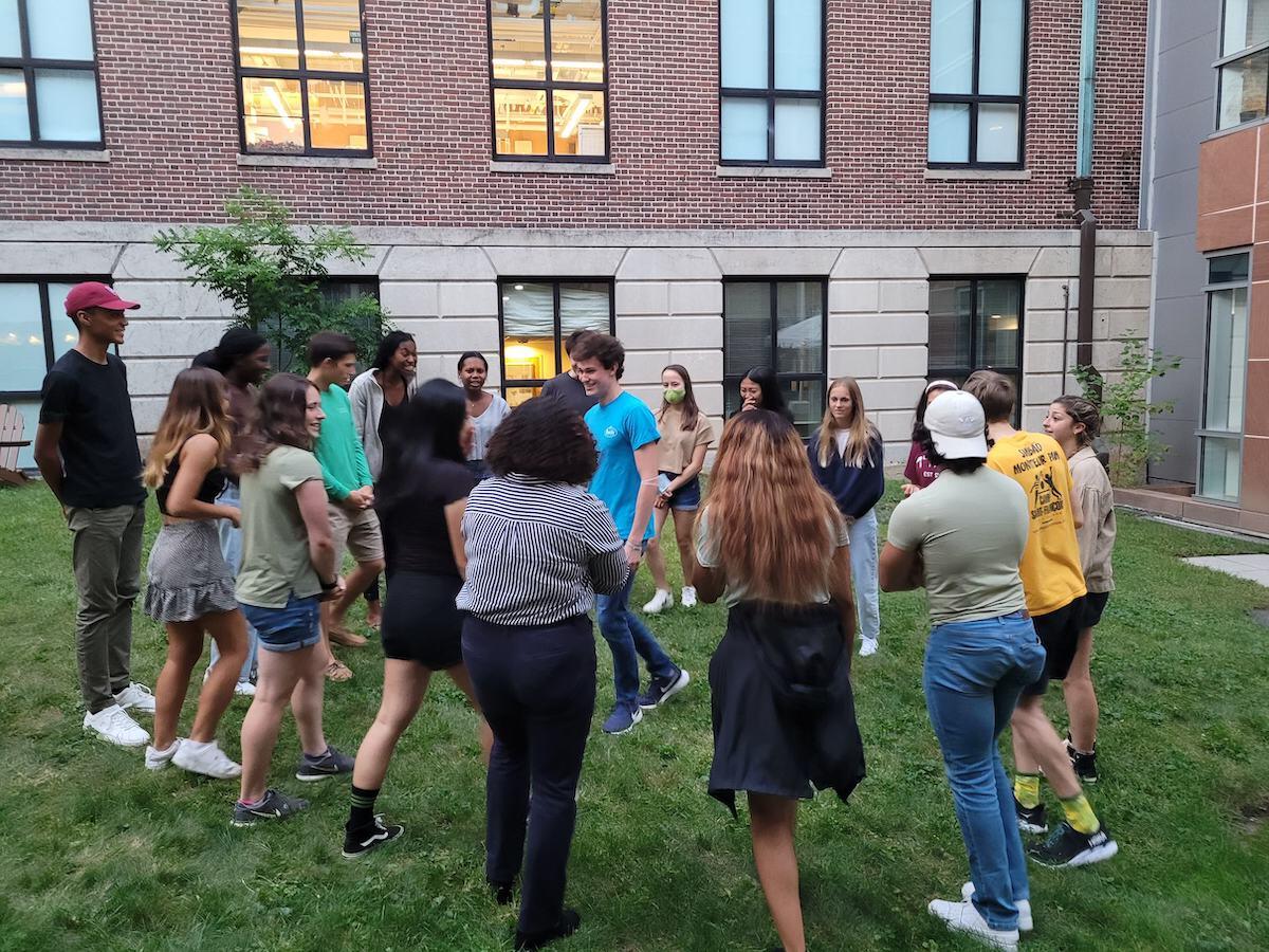 Students at an event outside of a House.