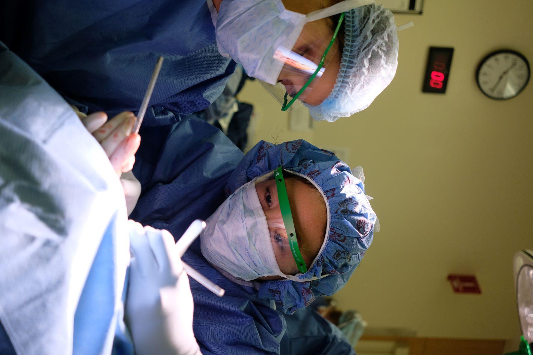 Residents performing an ENT procedure