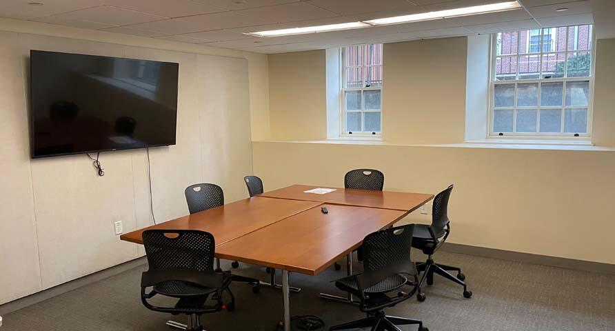 Photo of S009 with conference table and mounted TV