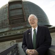 David Latham on roof of Observatory in front of old telescope dome.