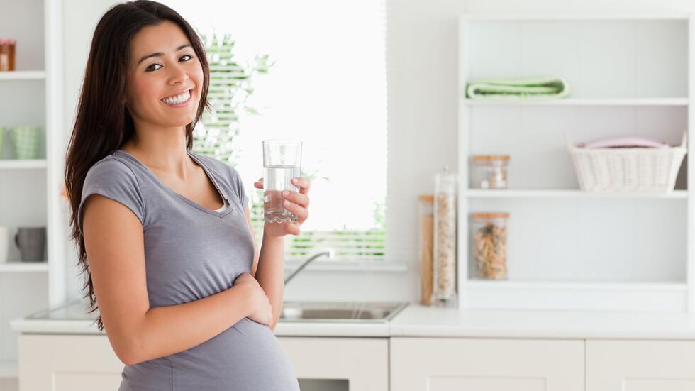 Pregnant woman with glass of water