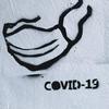 Image of a face mask with COVID-19 written on it