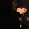 Student holds a candle at a peace vigil for Ukraine